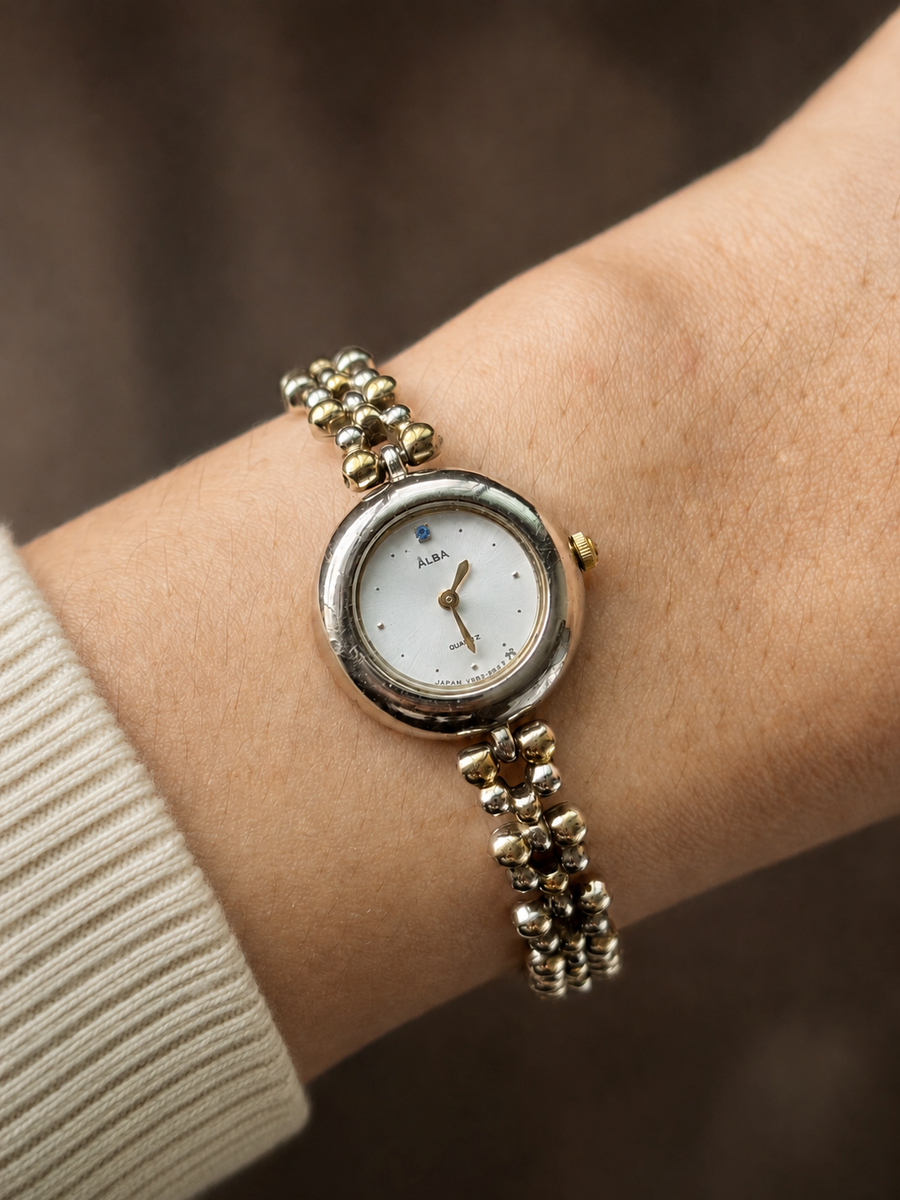 Vintage Alba two-tone beaded bracelet watch with blue jewel, front view